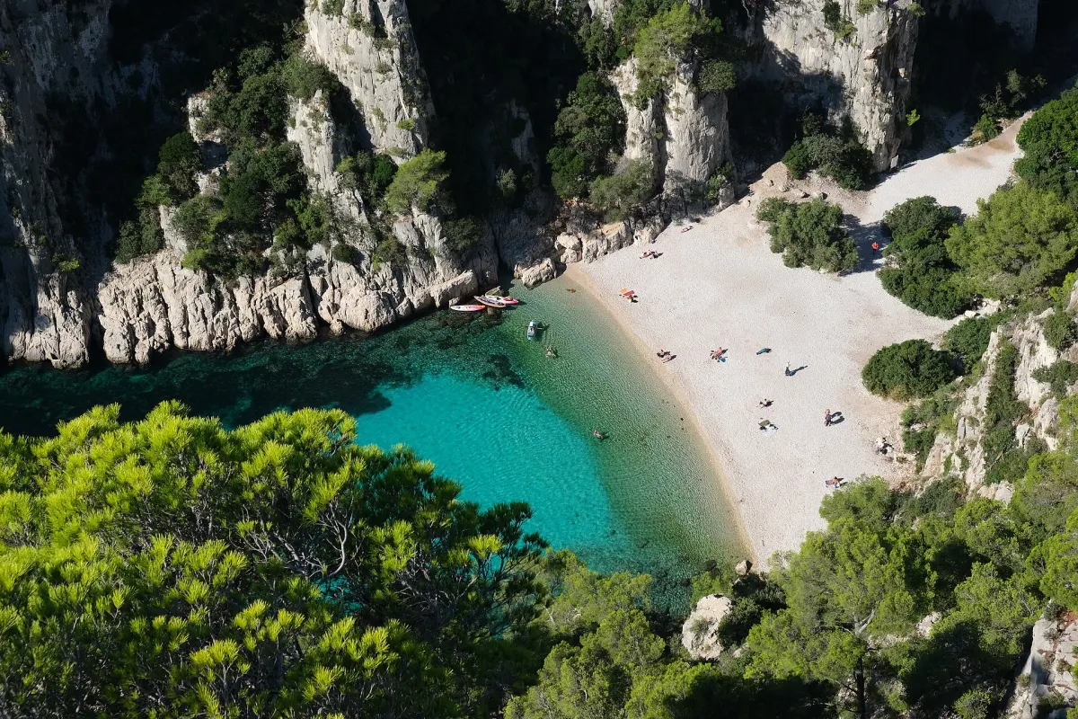 Calanque d’En-Vau: wąska zatoka z turkusową wodą między białymi wapiennymi ścianami
